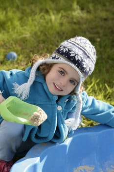 beautiful toddler girl winter wool hat portrait in outdoors