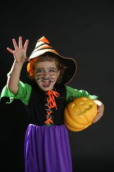 Toddler beautiful witch girl wearing halloween costume and make up