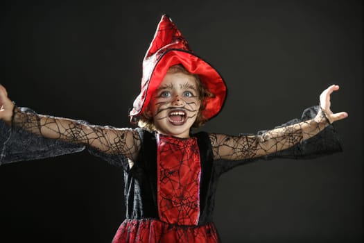 Toddler beautiful witch girl wearing halloween costume and make up