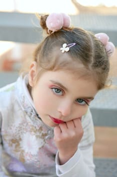 Beautiful little caucasian toddler girl with asian costume and makeup