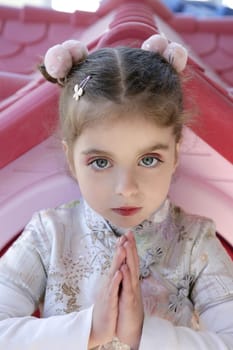 Beautiful caucasian little girl outdoor with asian dress ans makeup
