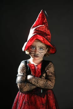 Toddler beautiful witch girl wearing halloween costume and make up