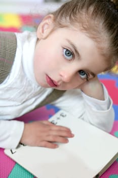 Beautiful preschooler little girl sutdent learning with homework book