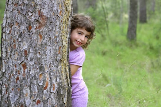 little girl hide park tree trunk green pine forest outdoor