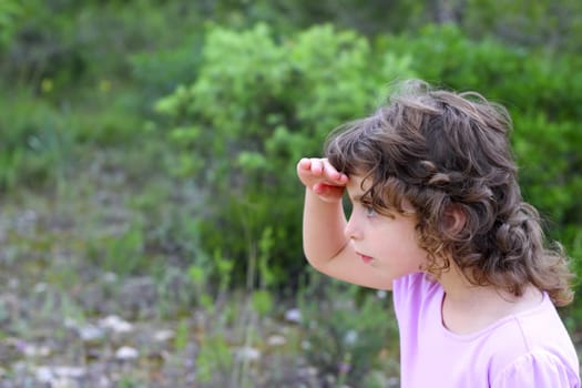 explorer little girl forest park searching hand in forehead