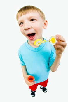 Portrait of cute boy preparing for blowing of soapy bubbles