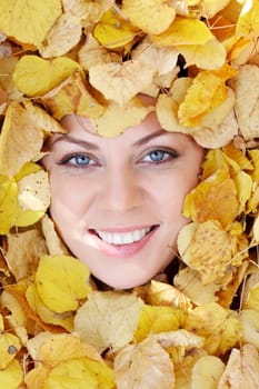 Close-up of face of beautiful woman in orange foliage