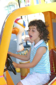 little gird playing driving toy car outdoor