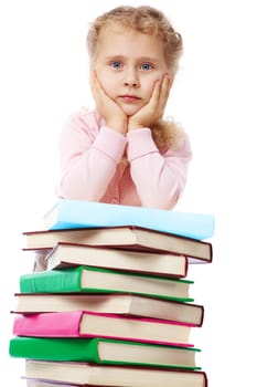 Portrait of a little girl at a heap of books