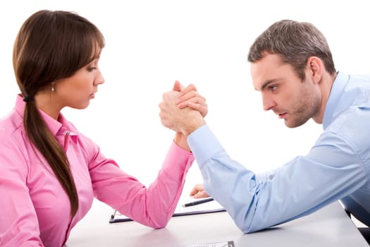 Man and woman in arm wrestling gesture on working table during meeting