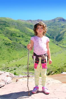 Explorer mountain girl hicker stick cane green outdoor valley landscape