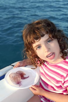 Girl with two jellyfish in white dish on boat blue mediterranean sea