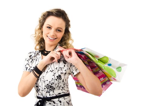 Photo of pretty girl holding paper bags and looking at camera over white background