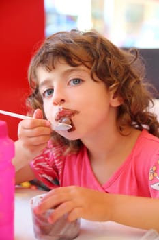 Girl eating chocolate ice cream dirty face having fun