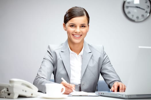 Image of young employer looking at camera while planning work in office
