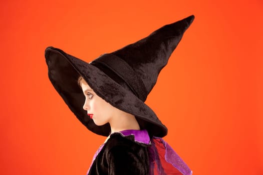 Halloween kid girl costume on orange background