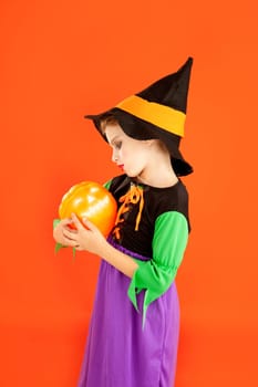 Halloween kid girl costume on orange background