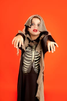 Halloween kid girl costume on orange background