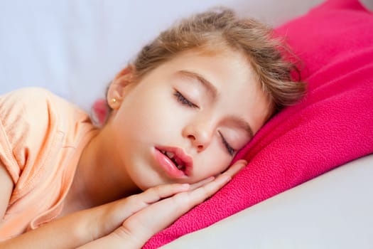 Deep sleeping children girl closeup portrait on pink pillow