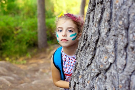 children little girl playing in forest tree with party makeup