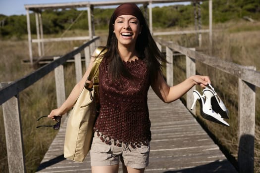 beautiful nature tourist woman, running stressed outdoor with shoes in hand