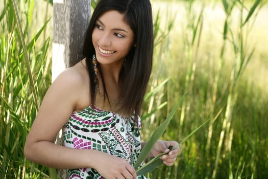 Portrait of beautiful indian woman on nature, cane field