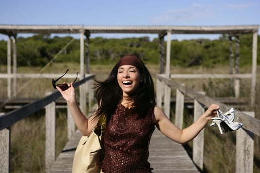 beautiful nature tourist woman, running stressed outdoor with shoes in hand