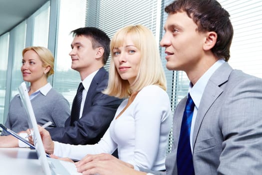 Four business people working at conference
