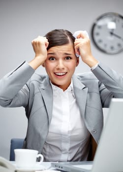 Image of shocked employer touching her head at workplace