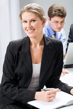 Portrait of smart woman sitting at the table in a business environment
