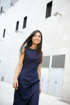 Beautiful blue dress stewardess walking to convention center