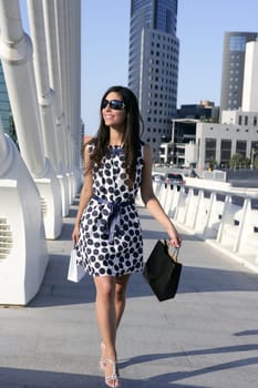 Beautiful brunette shopaholic outdoor modern city urban street