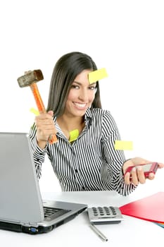 Angry brunette businesswoman with hammer against screen