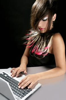 Attractive brunette fashion woman with laptop over black