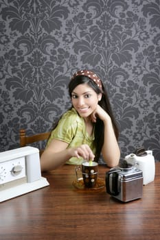 Retro woman drinking coffee on kitchen vintage wallpaper