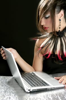 Attractive brunette fashion woman with laptop over black