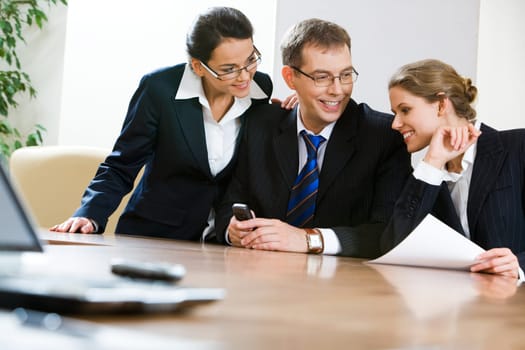 Image of business team sitting at the table in the office