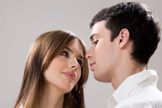 Photo of pretty girl and handsome guy looking at each other with admiration