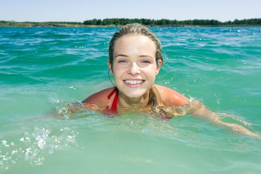 Portrait of wet attractive woman in the water