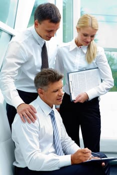 Photo of successful employees discussing business plan at meeting