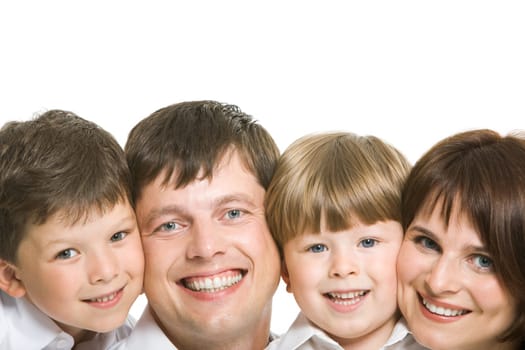 Faces of four family members looking at camera with happy smiles on white background