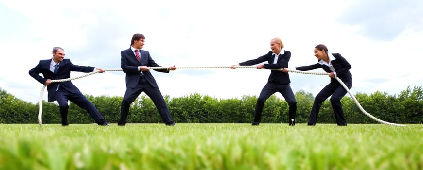 Photo of business people stretching the rope in the stadium