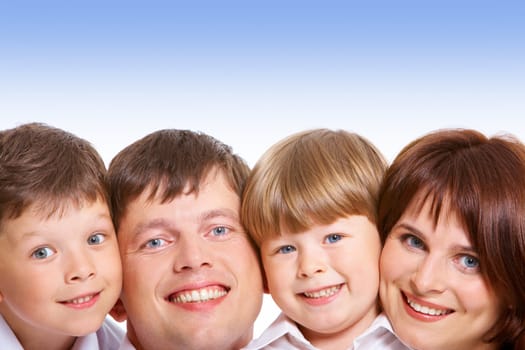 Faces of four family members looking at camera