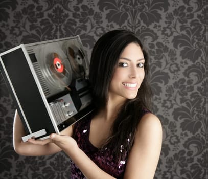 Retro open reel tape recorder beautiful brunette Dj hearing music gray walpaper