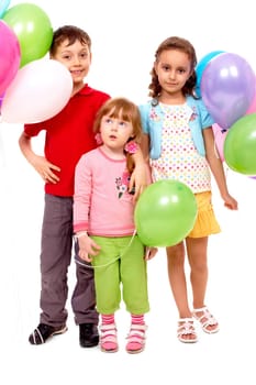 Portrait of kids with colorful balloons at birthday party