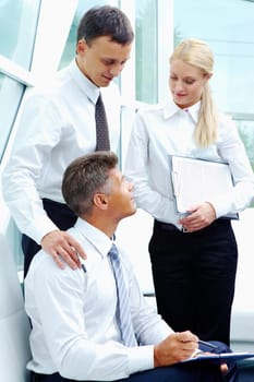 Photo of successful employees discussing business plan at meeting
