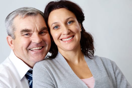 Portrait of happy middle aged woman and senior man looking at camera