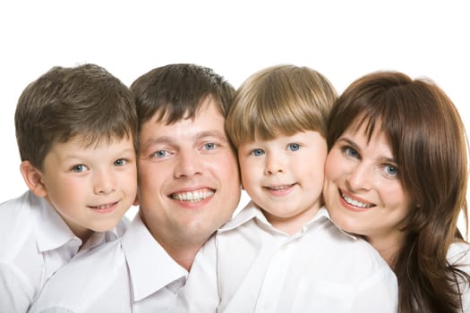 Happy couple and their two sons looking at camera face to face
