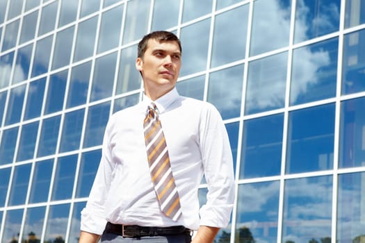 Portrait of confident businessman on background of office building