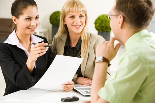 Portrait of business team communicating at meeting in the office